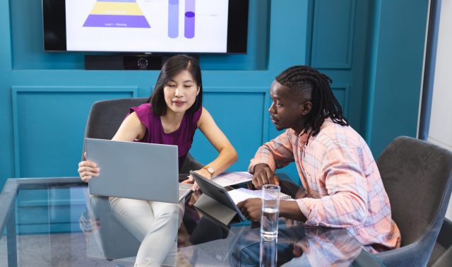 Team members collaborating on a project on the computer