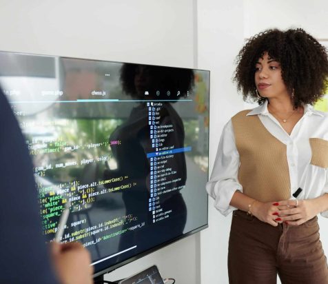 Woman looking at programming code on a computer